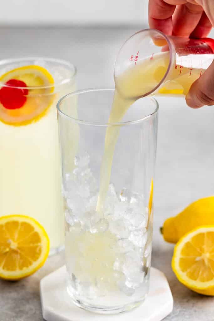 process shot of mocktail tom collins being made.