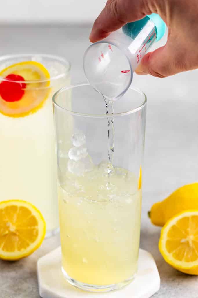 process shot of mocktail tom collins being made.