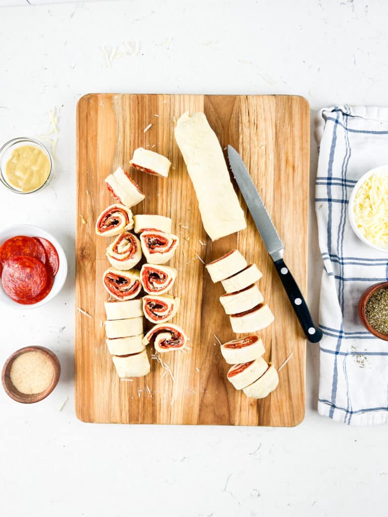 process shot of pizza pinwheels being made.