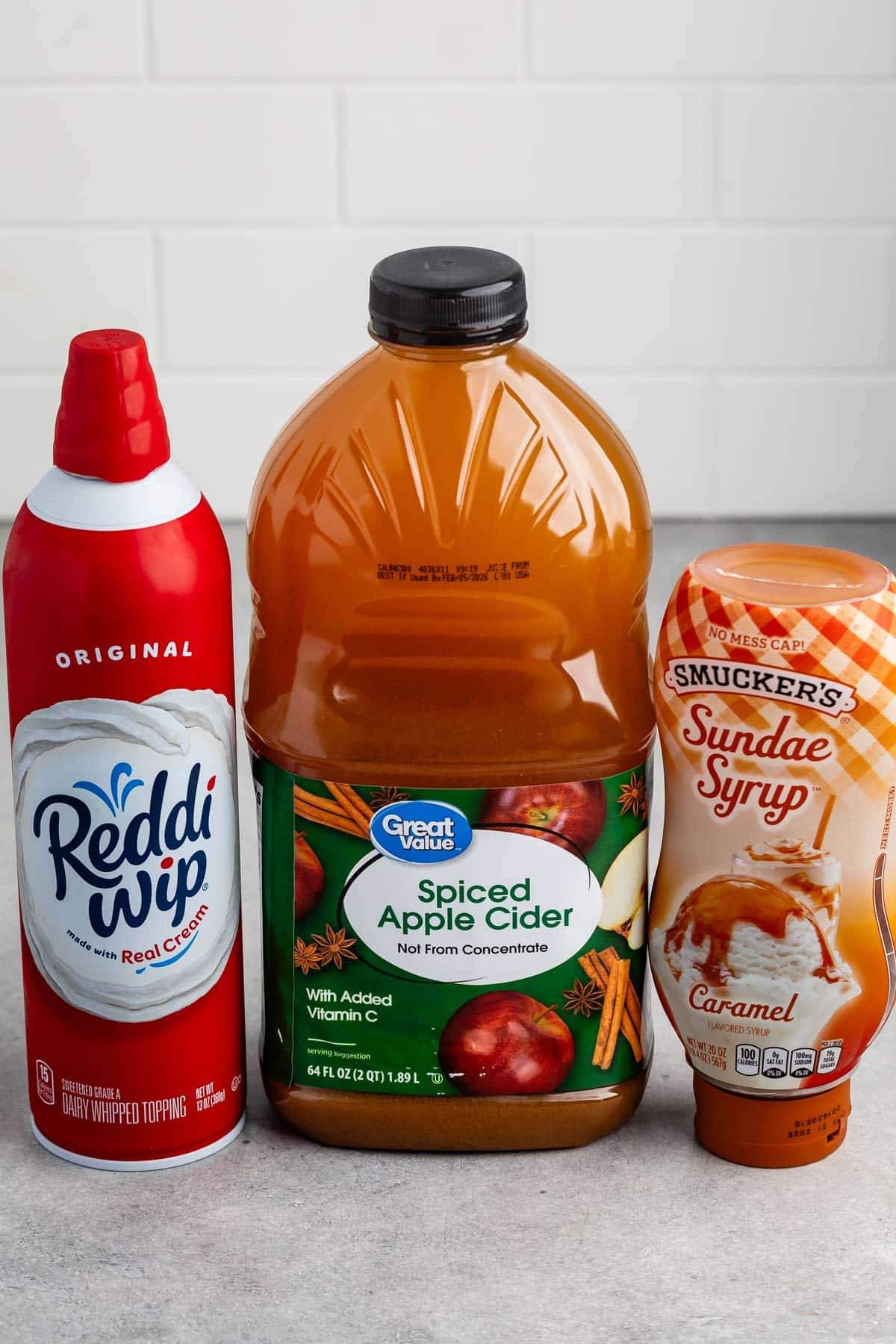 ingredients in apple cider float laid out on a grey counter.