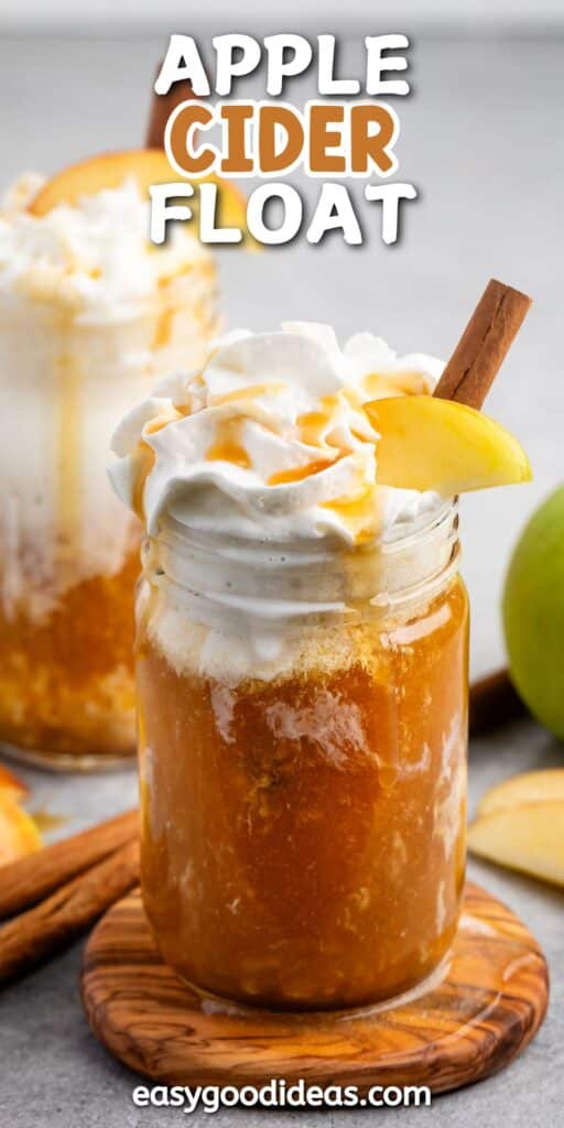 apple cider and whipped cream in a clear mason jar with caramel sauce and sliced apples on top with words on the image.