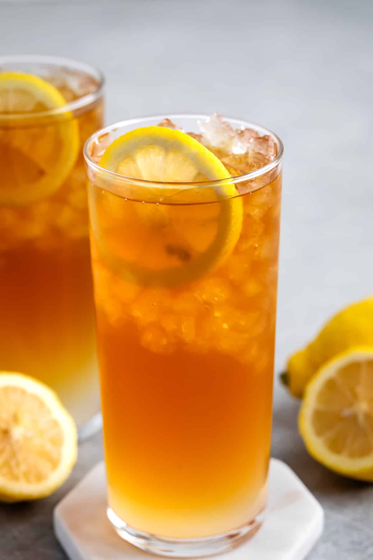 orange drink in a tall clear glass.