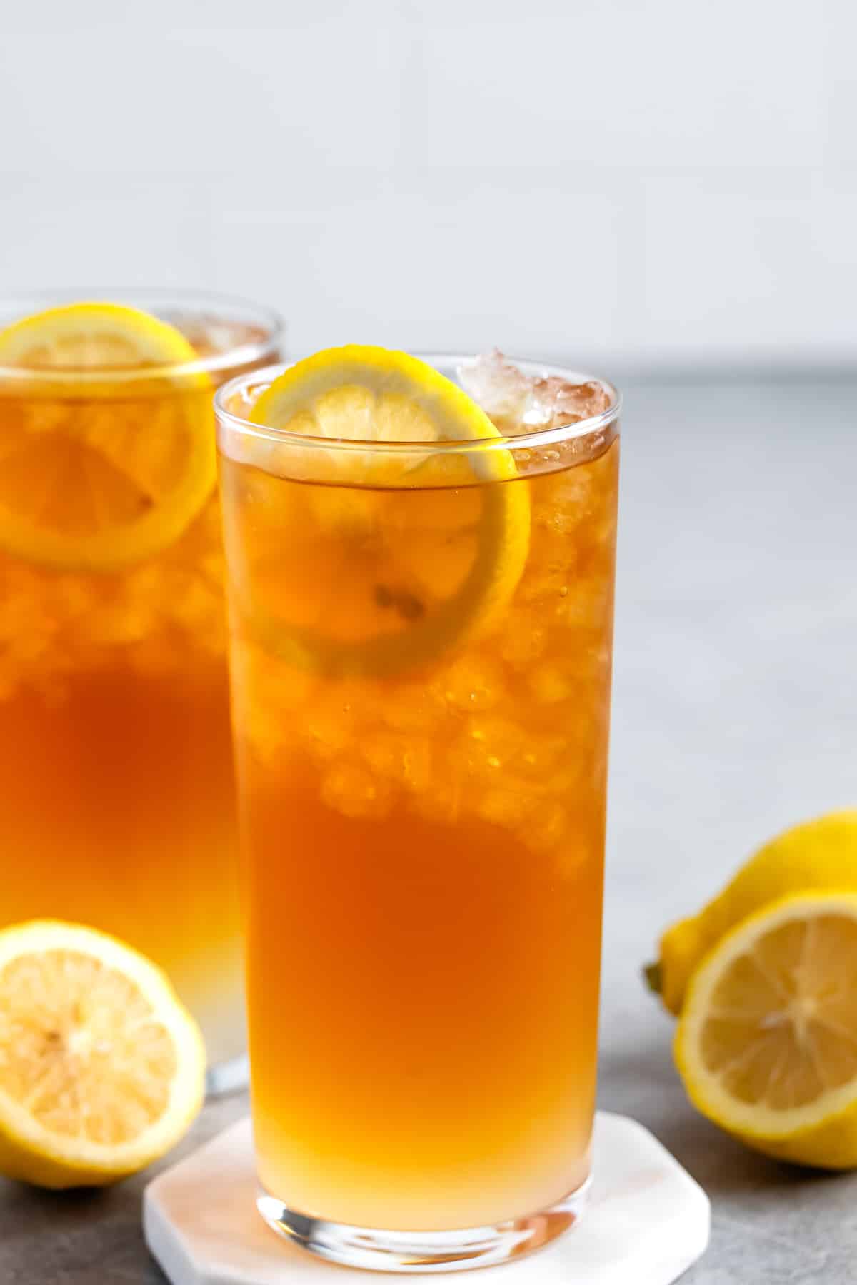 orange drink in a tall clear glass.