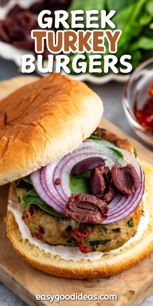 turkey burger on a cutting board topped with onions and spinach and buns with words on the image.