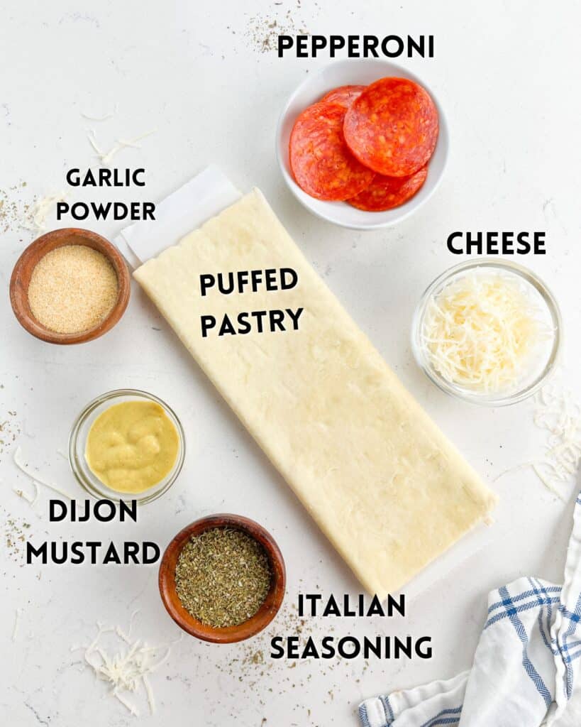 ingredients in pizza pinwheels laid out on a white counter.