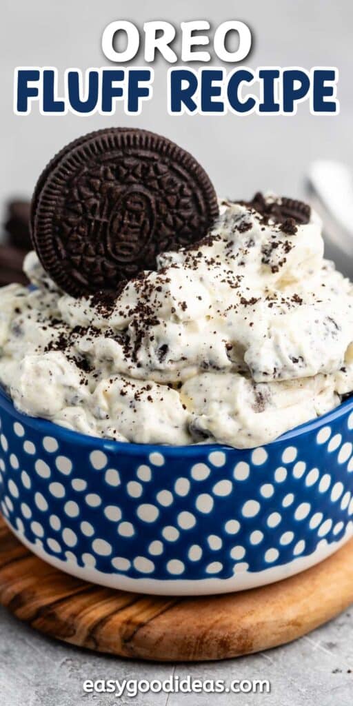 A bowl of Oreo fluff dessert topped with whole and crushed Oreo cookies. The fluffy mixture is served in a blue polka-dotted bowl on a wooden surface. Text overlay reads: OREO FLUFF RECIPE and easygoodideas.com.