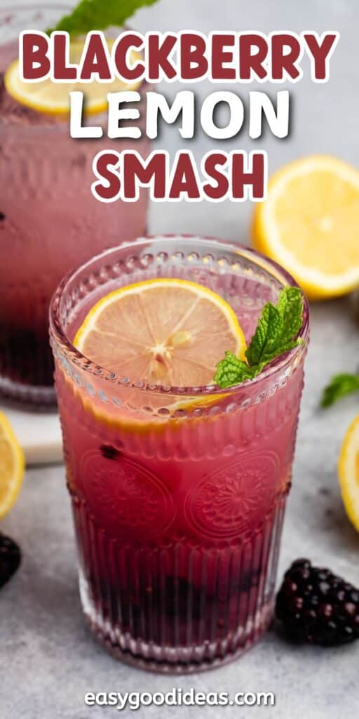 A close-up of a vibrant Blackberry Lemon Smash cocktail in a textured glass, garnished with a lemon slice and mint sprig. Another similar drink and sliced lemons are in the background. The text Blackberry Lemon Smash is at the top.