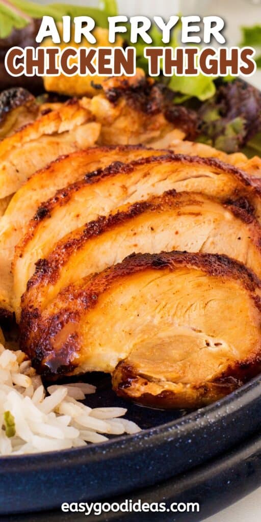 Close-up of sliced, golden-brown air-fried chicken thighs served on a plate with a side of rice and greens. A text overlay reads Air Fryer Chicken Thighs at the top and easygoodideas.com at the bottom.