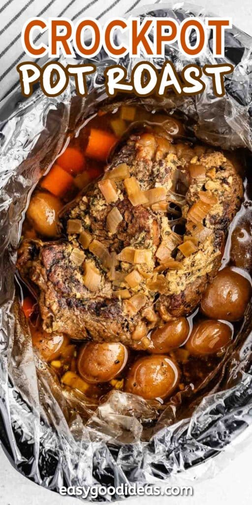 A crockpot filled with a cooked pot roast, featuring chunks of meat, carrots, onions, and small potatoes, all nestled in a rich broth. The dish is set inside a foil-lined crockpot. Text reads Crockpot Pot Roast easygoodideas.com.