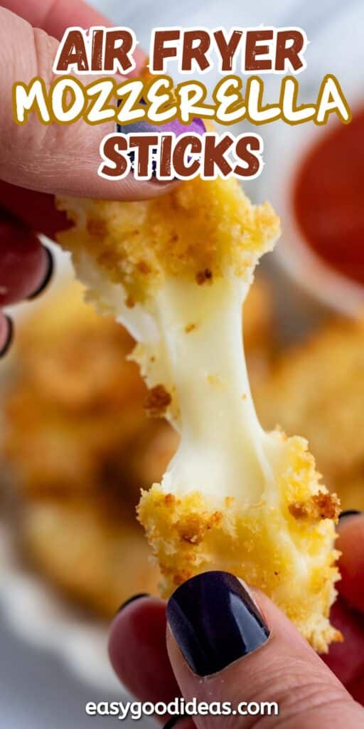 Close-up of hands pulling apart a crispy, breaded mozzarella stick, showing gooey cheese. A small cup of marinara sauce is blurred in the background. Text on the image reads Air Fryer Mozzarella Sticks, and the website easygoodideas.com is visible.