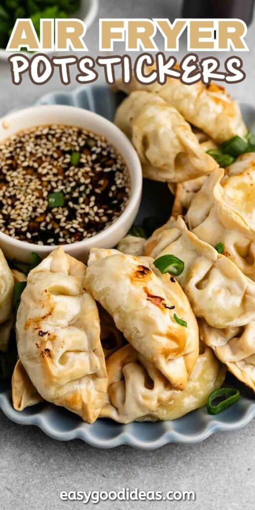 A plate of air-fried potstickers is served with a small bowl of soy sauce topped with sesame seeds. Green onions are scattered around the potstickers, adding color to the dish. The text at the bottom reads easygoodideas.com.