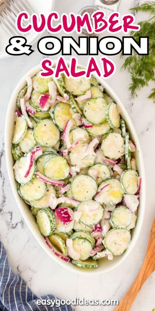 A dish of cucumber and onion salad with creamy dressing in an oval bowl. Sliced cucumbers and red onions are mixed together. Fresh dill is nearby. The text Cucumber & Onion Salad is at the top, and easygoodideas.com is at the bottom.