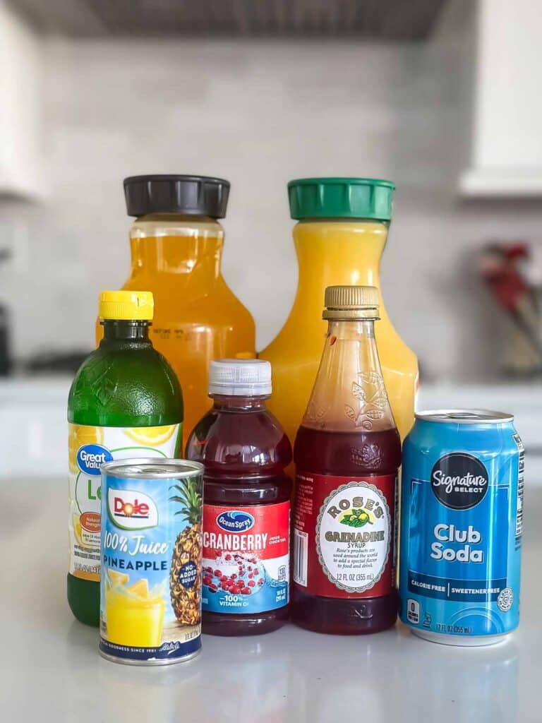 ingredients in island breeze mocktail laid out on a grey counter.