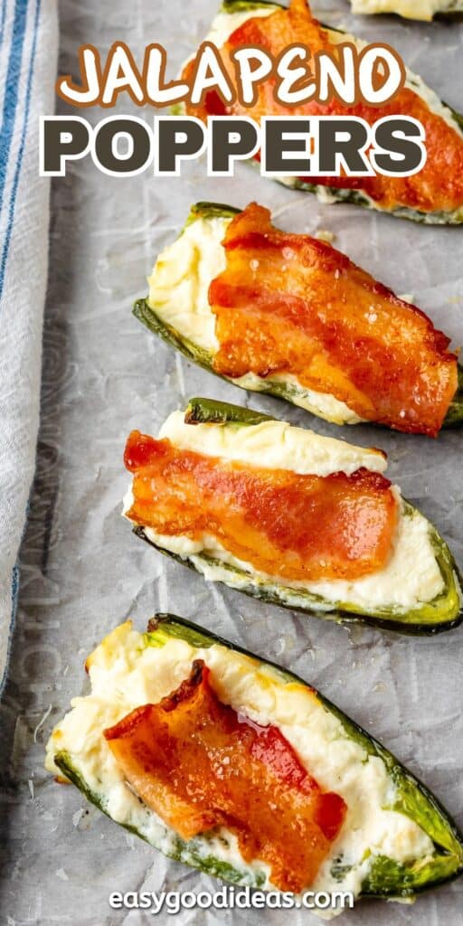 jalapeños covered in cream cheese and bacon laid out on parchment paper with words on the image reading the name of the recipe.