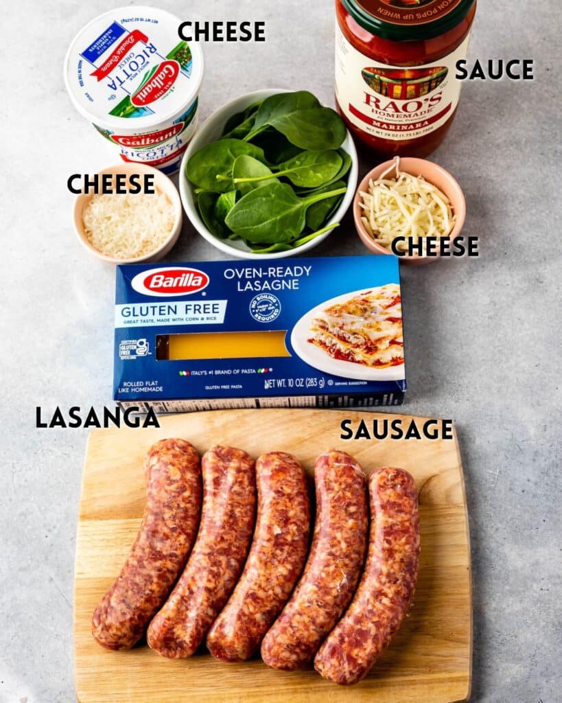 ingredients in skillet lasagna laid out on a grey surface with words describing the ingredients in the image.