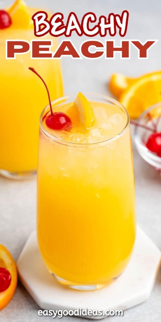 A glass of bright orange cocktail garnished with a red cherry and orange slice, set on a white coaster. In the background, there are orange slices and another similar drink. The text reads BEACHY PEACHY and easygoodideas.com.