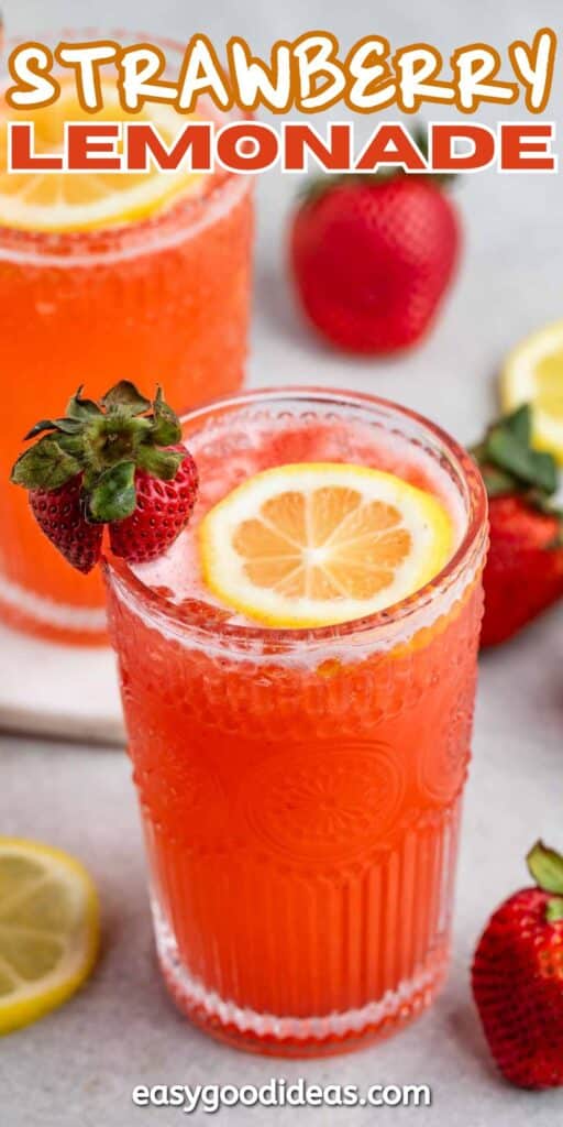 Two glasses of bright red strawberry lemonade garnished with lemon slices and fresh strawberries. Additional strawberries and lemon slices are scattered around. Text at the bottom reads easygoodideas.com.