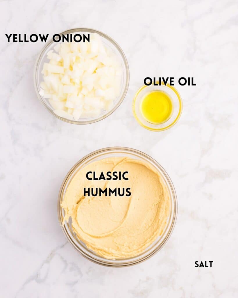Three labeled bowls on a marble surface contain yellow onion (diced), olive oil, and classic hummus. The word salt is listed in the corner, but not pictured.