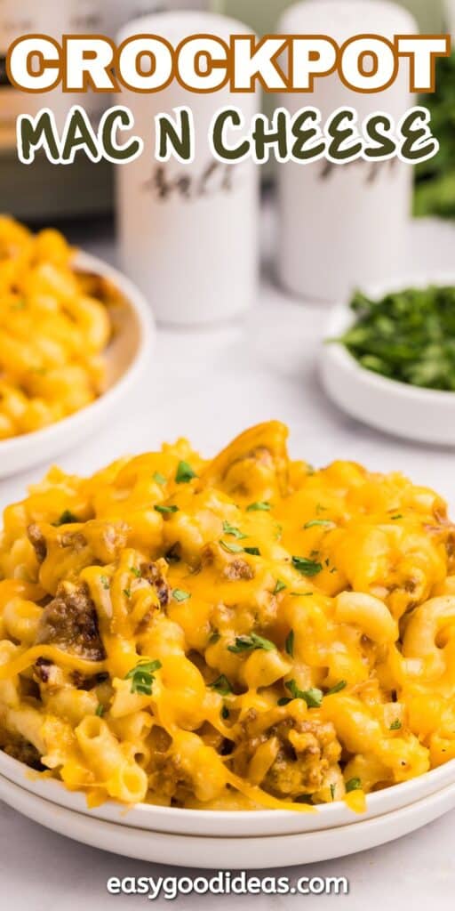 A close-up of creamy, cheesy mac and cheese topped with parsley, served in a white bowl. The text Crockpot Mac N Cheese is at the top, and easygoodideas.com is at the bottom.