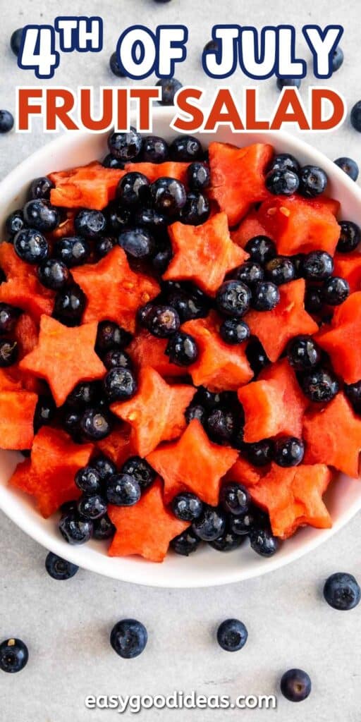 A bowl of fruit salad with star-shaped watermelon pieces and blueberries, surrounded by scattered blueberries. The text on the image reads 4th of July Fruit Salad and easygoodideas.com.