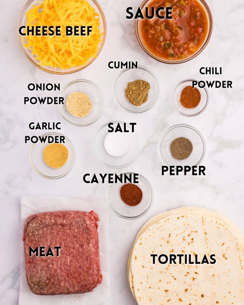 Ingredients for tacos or burritos arranged on a white surface, including shredded cheese, salsa sauce, various spices, ground beef, and flour tortillas, each labeled with black text.