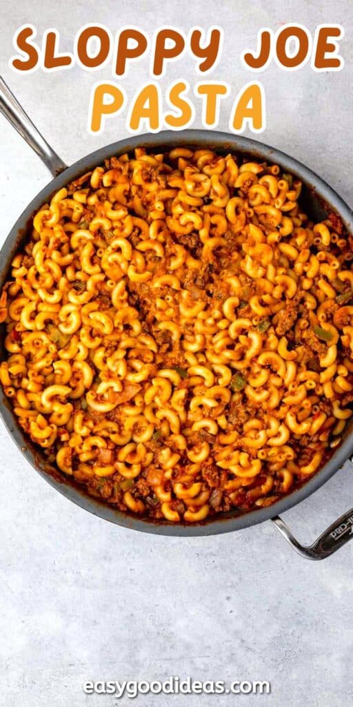 A skillet filled with Sloppy Joe pasta, featuring macaroni noodles mixed with a saucy ground meat and tomato mixture. Text above the pan reads Sloppy Joe Pasta.