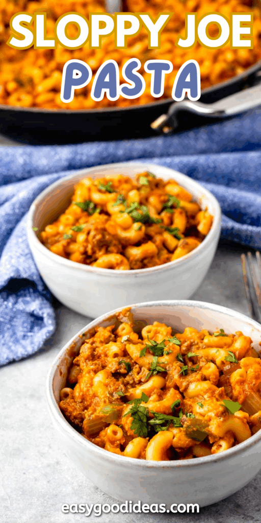 Two white bowls filled with cheesy sloppy joe pasta topped with herbs, with a skillet of more pasta in the background and a blue cloth napkin nearby. Text reads Sloppy Joe Pasta and easygoodideas.com.