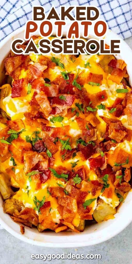 A casserole dish filled with baked potato casserole topped with melted cheese, crispy bacon pieces, and chopped parsley. A blue and white cloth is visible in the background. Text reads Baked Potato Casserole.