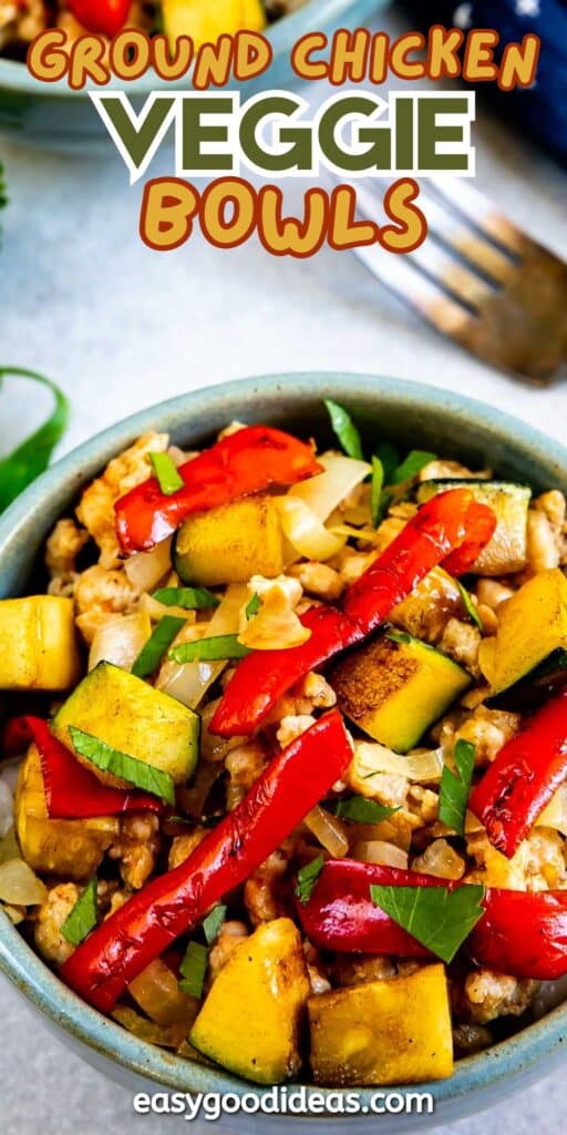 A veggie bowl filled with cooked ground chicken, zucchini, red bell peppers, chopped onions, and fresh herbs. Text above the bowl reads “Ground Chicken Veggie Bowls.”.