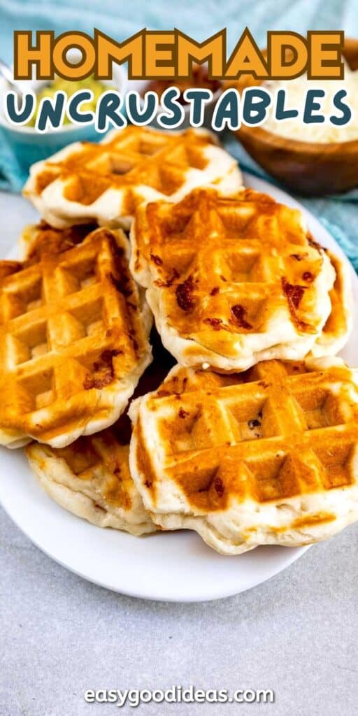 A plate piled with golden, waffle-shaped sandwiches labeled Homemade Uncrustables, with a blue cloth and bowl in the background. The easygoodideas.com website is written at the bottom.