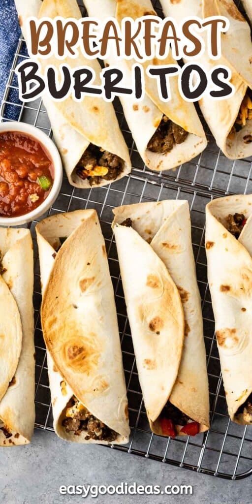 A batch of breakfast burritos filled with various ingredients sits on a wire rack next to a small bowl of salsa. The words Breakfast Burritos and easygoodideas.com appear on the image.