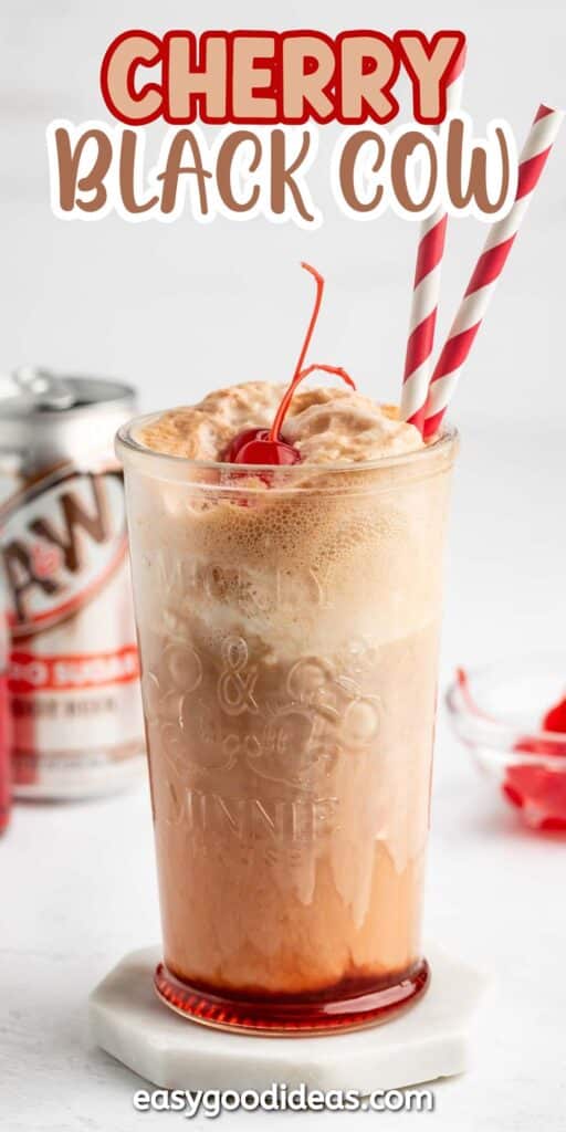 A glass of cherry black cow float with foamy root beer, vanilla ice cream, cherries on top, and two red striped straws. A can of A&W root beer and a dish of cherries are in the background.