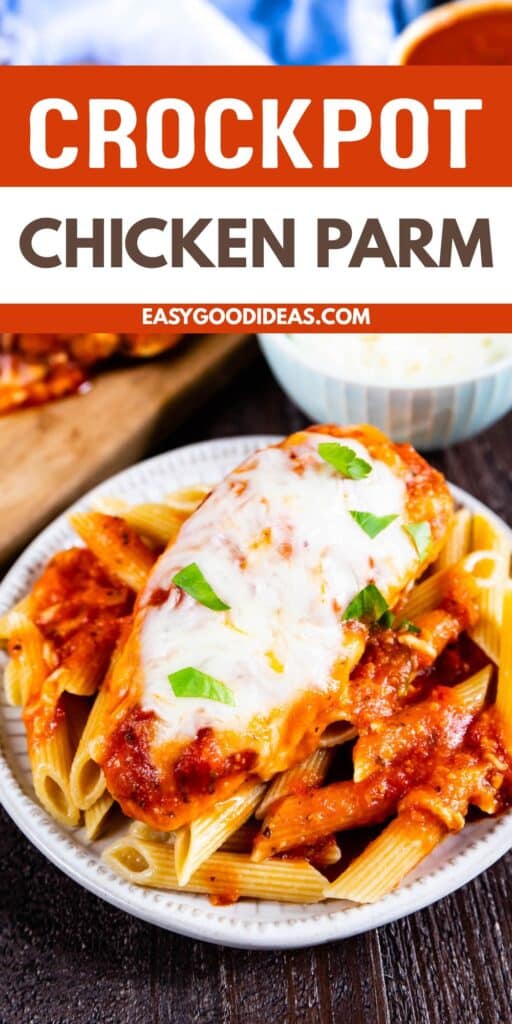A plate of baked chicken parmesan topped with melted cheese and basil sits on penne pasta with tomato sauce. The text above reads Crockpot Chicken Parm and easygoodideas.com.