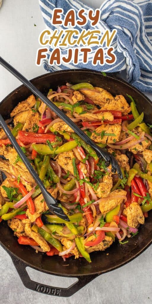 A skillet filled with colorful chicken fajitas, including sliced chicken, red and green bell peppers, and onions, with black tongs on top. Above the skillet, text reads Easy Chicken Fajitas next to a blue-striped towel.