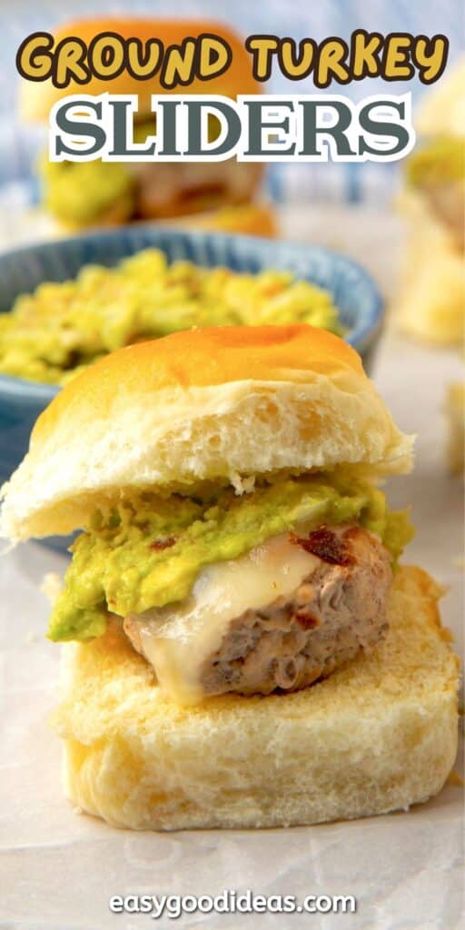 A ground turkey slider on a soft bun topped with melted cheese and mashed avocado, with more sliders in the background. Text reads Ground Turkey Sliders and easygoodideas.com at the bottom.