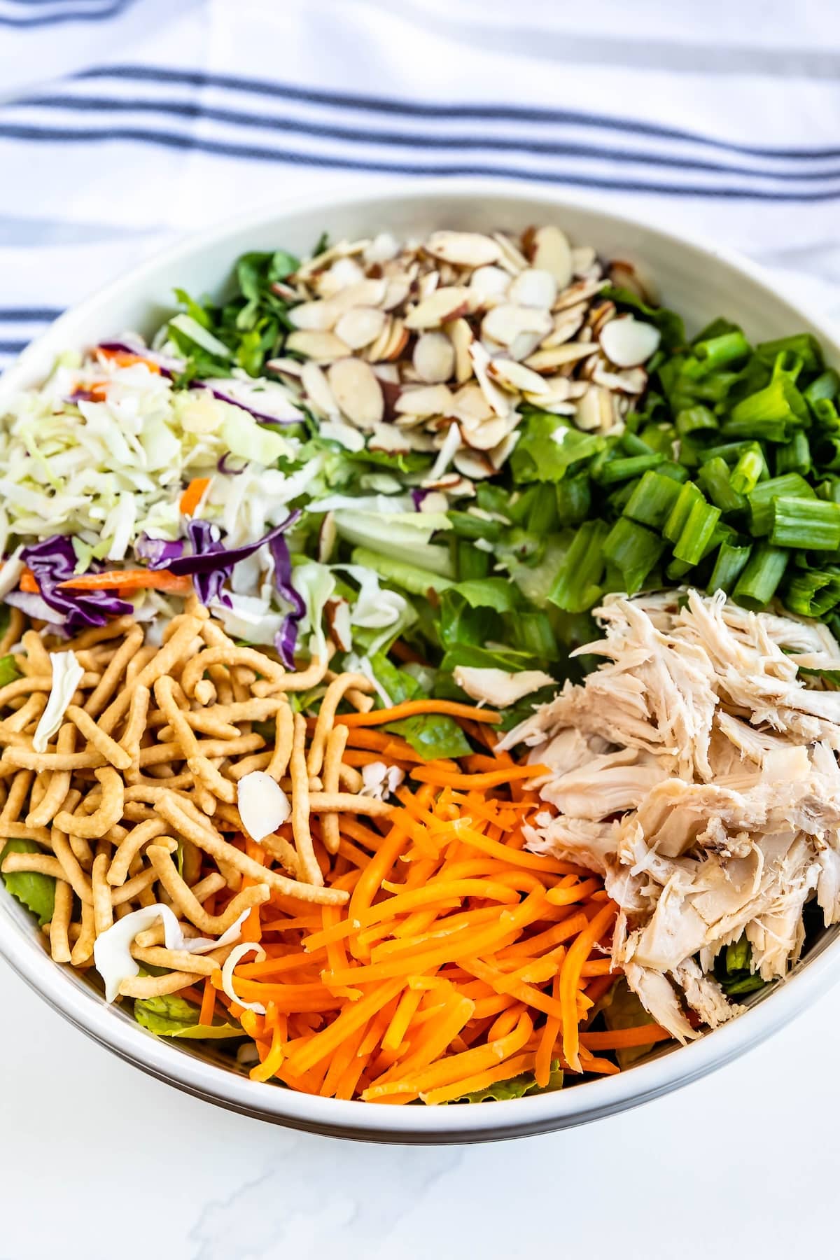 A bowl of food with meat and vegetables.