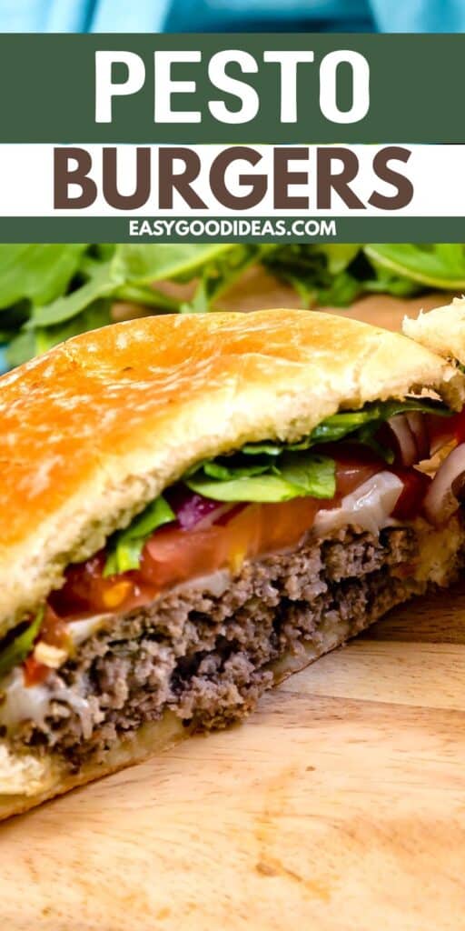 A close-up of a sliced pesto burger on a wooden board, with layers of lettuce, tomato, red onion, cheese, and a beef patty inside a golden bun. Text above reads Pesto Burgers and easygoodideas.com.