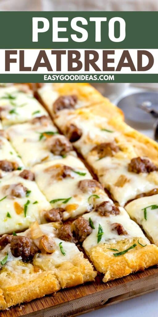 Rectangular slices of pesto flatbread topped with melted cheese, sausage, and herbs are arranged on a wooden board. A pizza cutter is partially visible in the background.