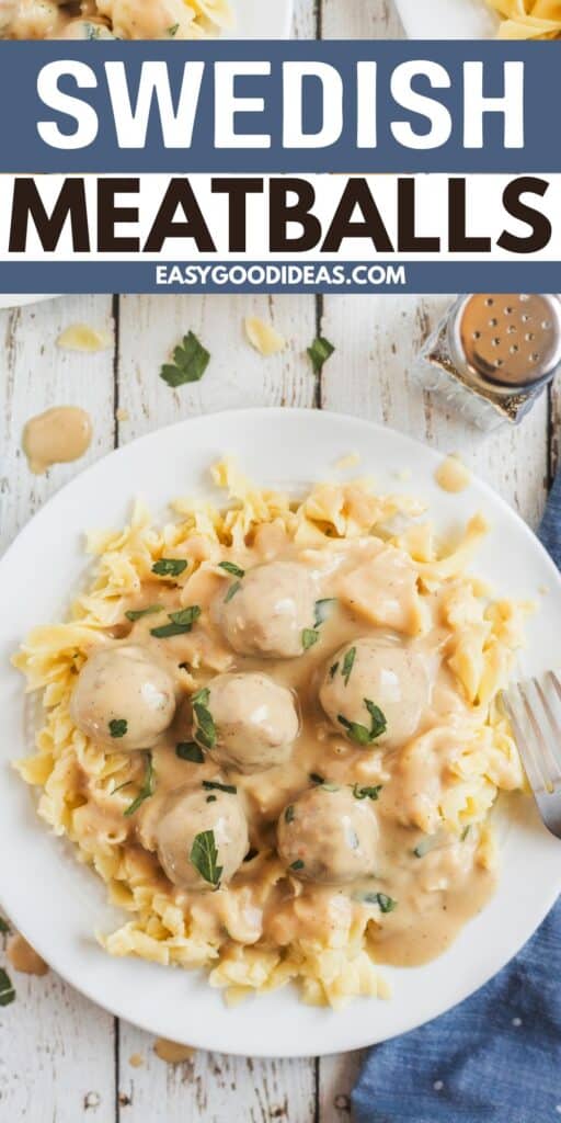 A plate of Swedish meatballs with creamy gravy served over egg noodles, garnished with chopped parsley. A pepper shaker and a blue napkin are beside the plate on a white wooden table. Text reads “Swedish Meatballs.”.