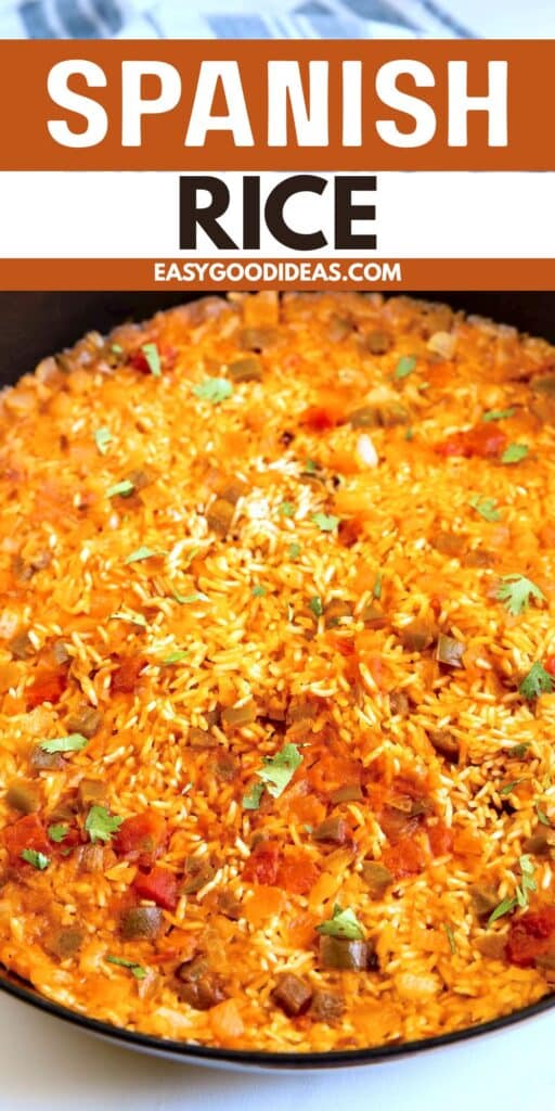 A close-up of a pan filled with bright orange Spanish rice, garnished with chopped cilantro, diced tomatoes, and bits of vegetables. The text Spanish Rice and easygoodideas.com appears at the top.
